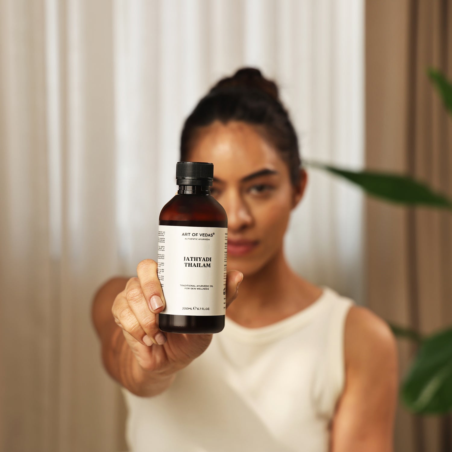 Art of Vedas Jathyadi Thailam Ayurveda Oil - Woman Presenting Ayurvedic Oil for Wound Healing and Skin Repair